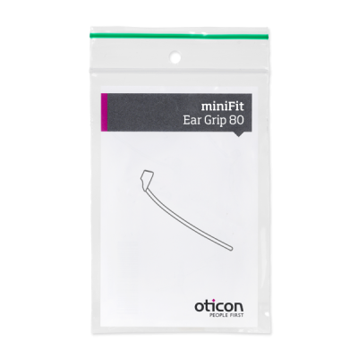 A clear plastic bag with a green zip seal contains an Oticon miniFit Ear Grip. The packaging features a line drawing of the ear grip and is labeled